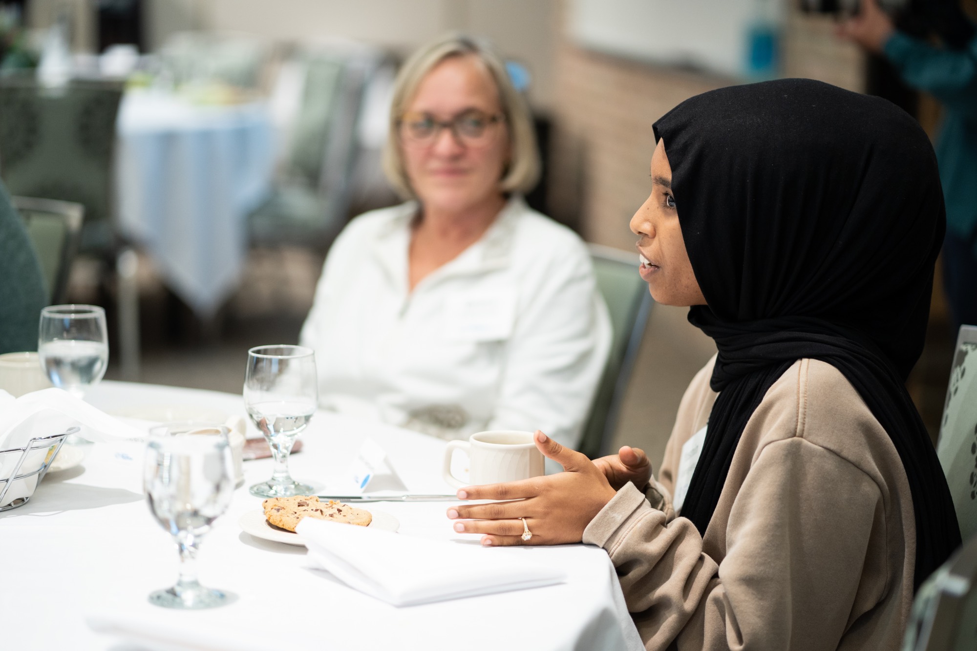 Students talking at event table